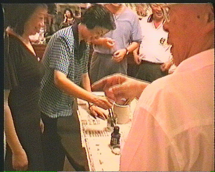 Master Hsu's wife prepares the calligraphy brushes for her guests and husband